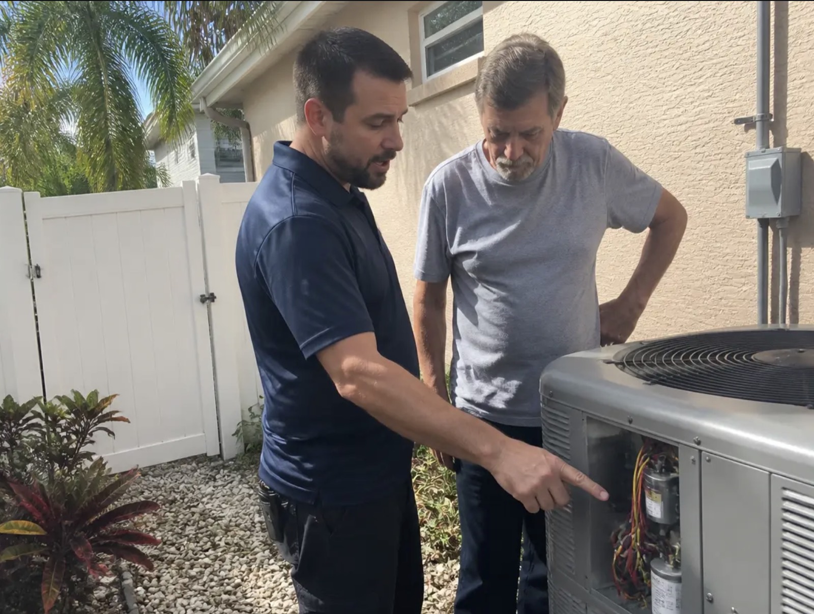 Frostline AC Repair technician diagnosing an AC unit in Delray Beach, FL