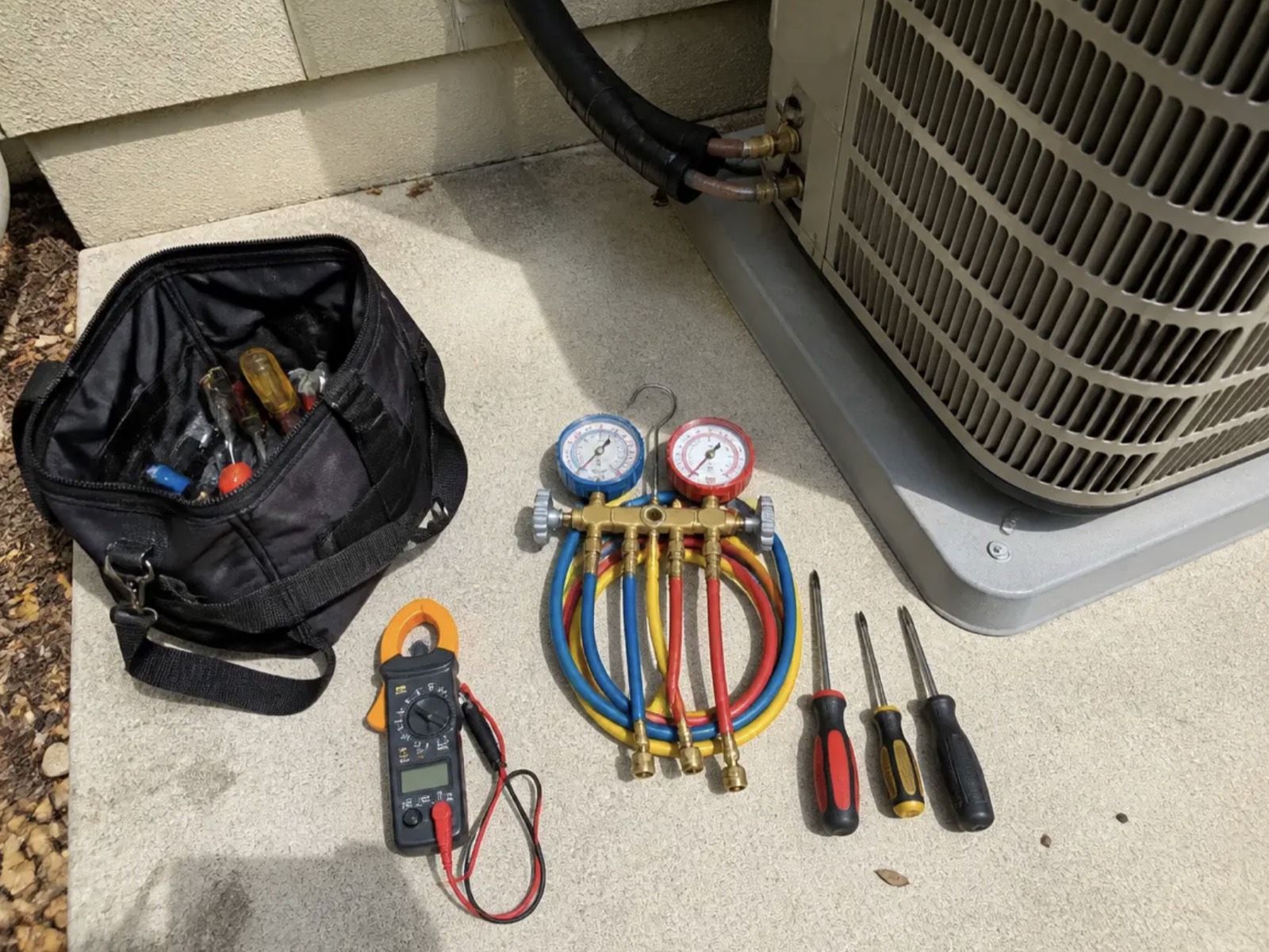 AC refrigerant gauges and electrical meter used to measure system efficiency