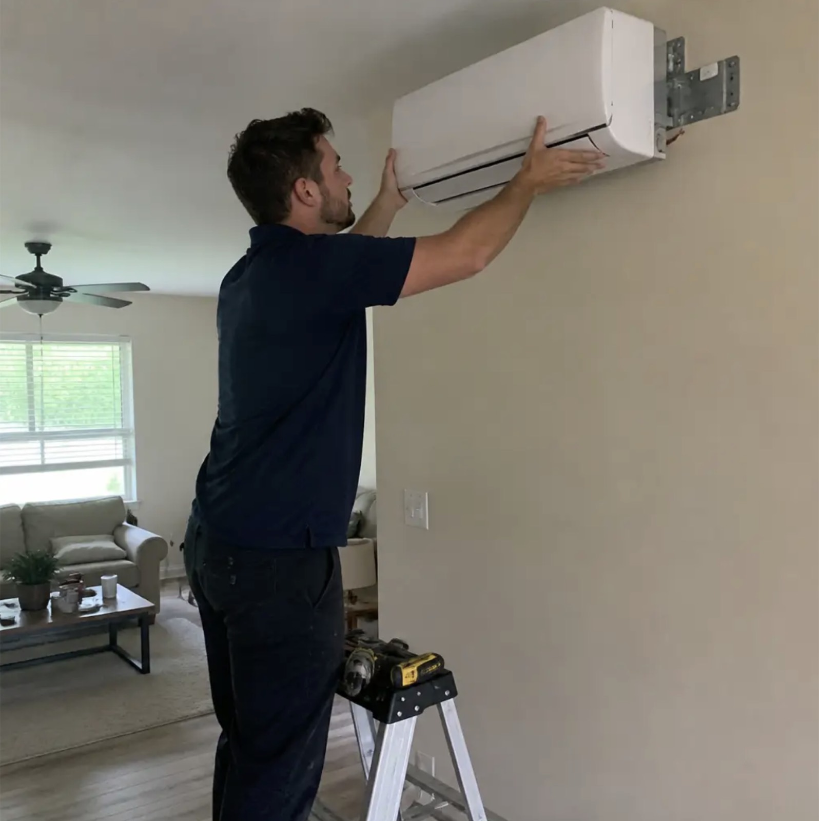Frostline technician installing a ductless mini-split wall unit