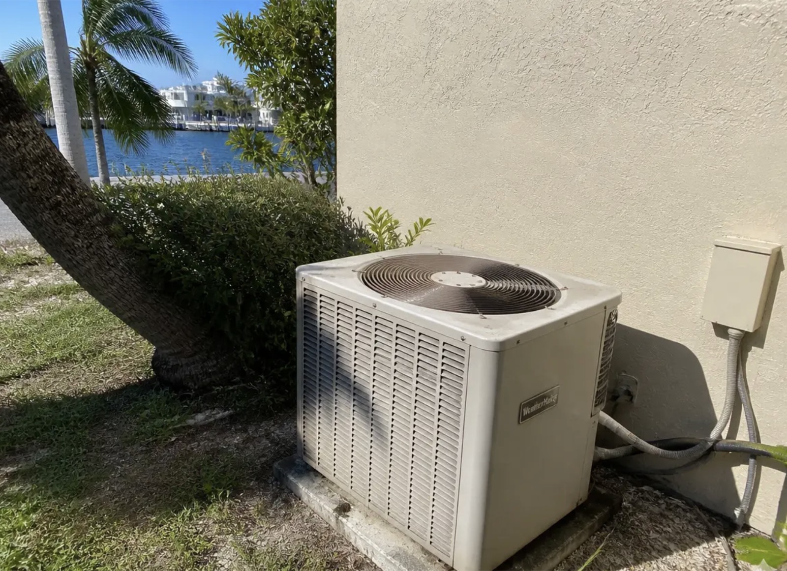 AC condenser serviced beside a Delray Beach waterfront home